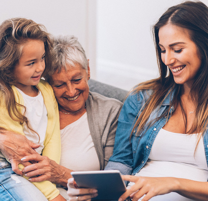 Three Generation women have fun at home with digital tablet