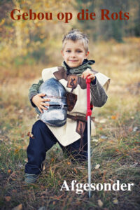 Portrait of a brave little knight kneeling. The boy is 4 and is wearing knight's outfit.